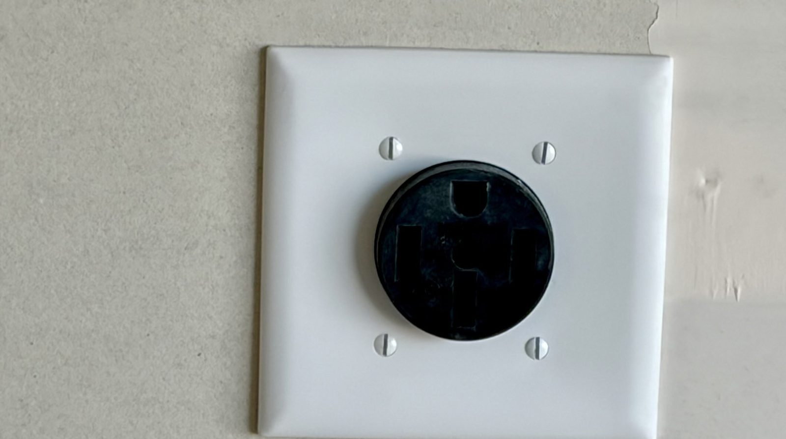 A NEMA 14-50 outlet installed in a garage for a home EV charger